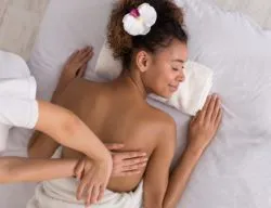 Woman getting a massage regarding the Novex Insurance class action lawsuit filed by massage therapist