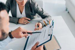Woman looking at guide regarding information on Great West Life long-term disability insurance