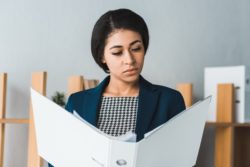 Woman reading insurance policy regarding information on long-term disability insurance Ontario