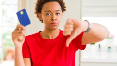 woman holding a card regarding the prepaid visa card settlement