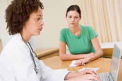 Doctor entering patient info regarding the Central Health privacy breach class action lawsuit 