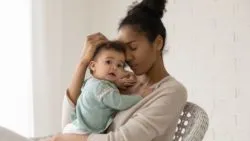 Mother holding child separated from father