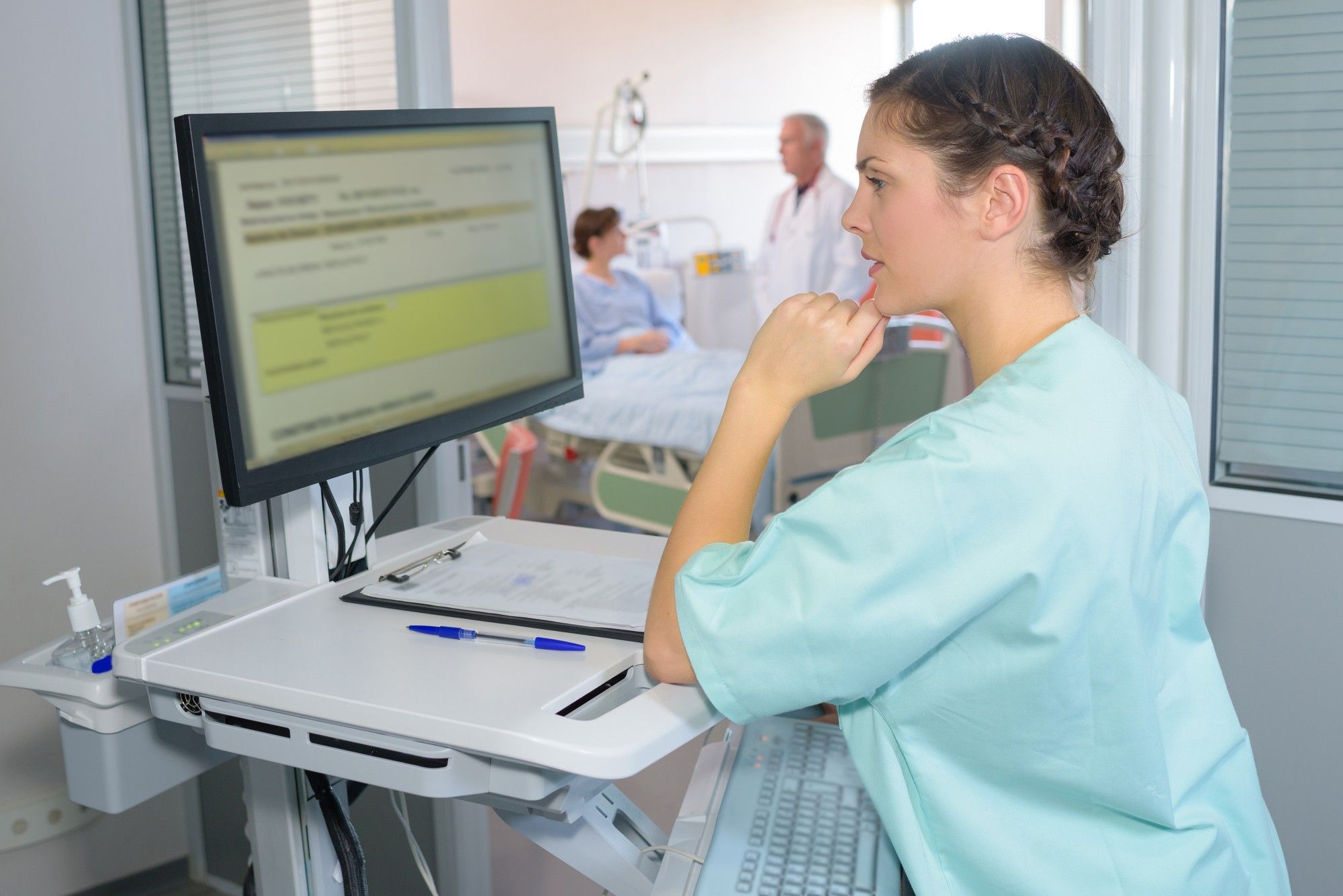 Nurse looking at patient info regarding the Central Health class action lawsuit to be filed