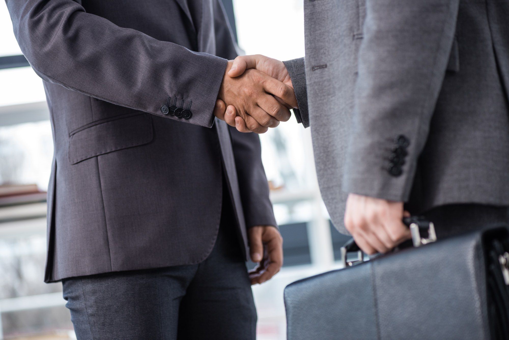 Insurance brokers handshake over secret kickback deal