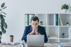 Upset man on laptop regarding the anonymous allegations Instagram page lawsuit filed