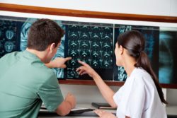 Nurses looking at MRI images regarding the secret indigenous study class action lawsuit 