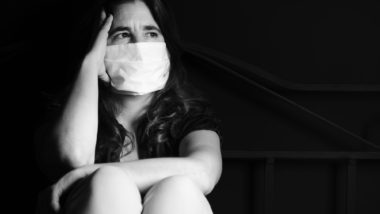 covid-19 woman wearing face mask sad