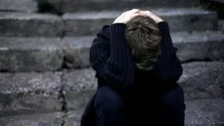 Sad boy with head in arms regarding the Catholic Church Appeals to The Supreme Court Over Sex Abuse Lawsuits