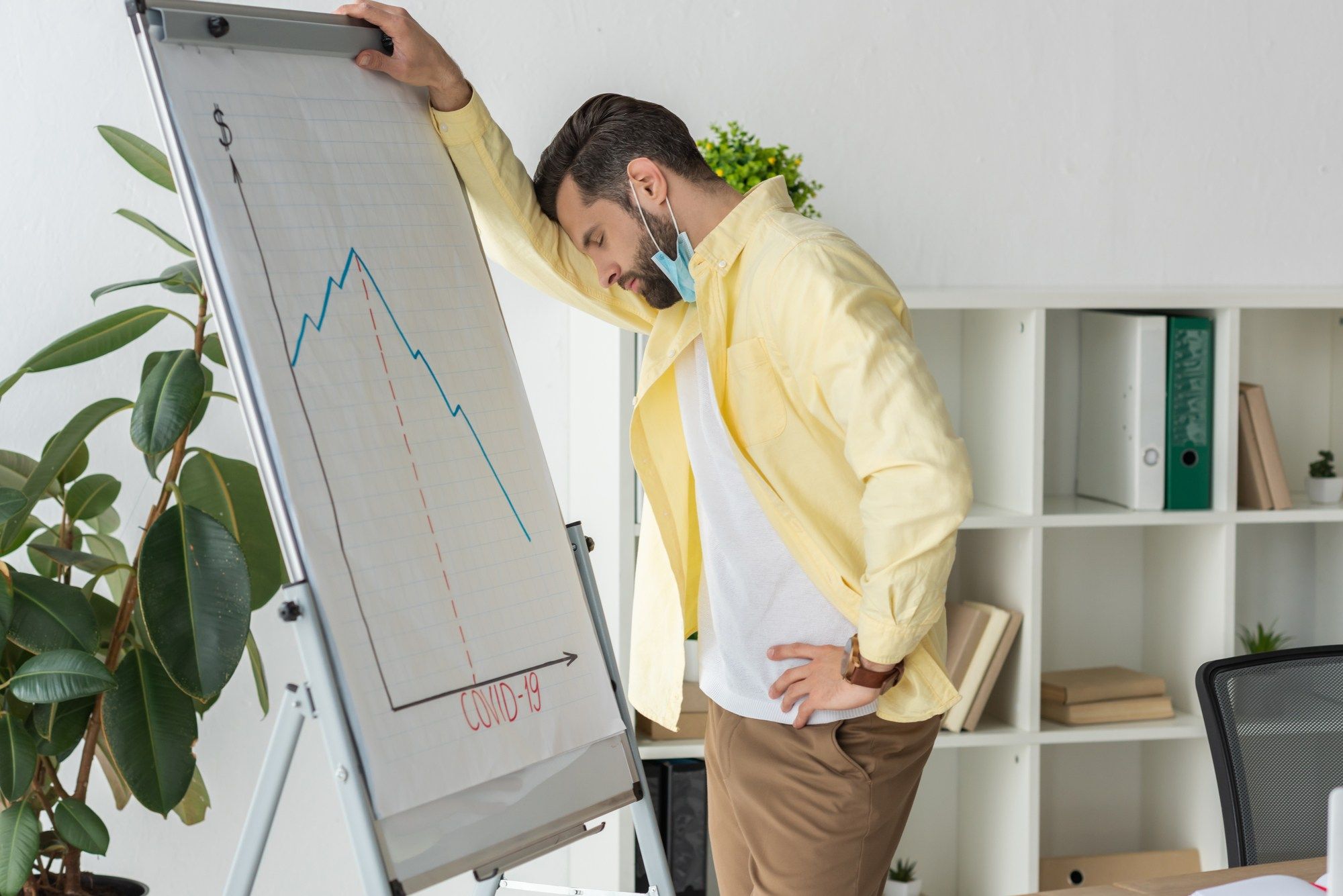 business owner looking at declining profits regarding the business interruption claim denial class action lawsuit