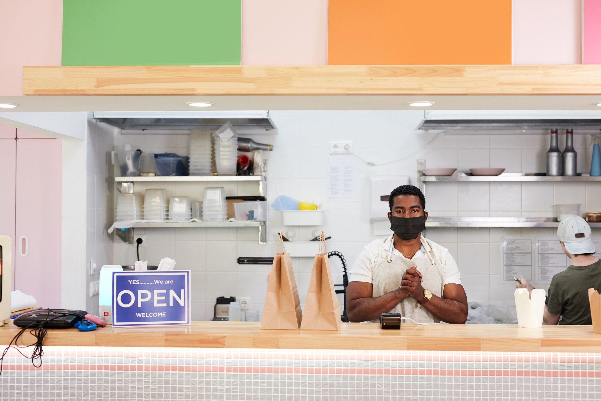 Business owner wearing mask regarding information about business interruption insurance claims