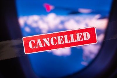 View out airplane window with word "cancelled" stamped over image - td bank