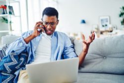 man trying to get flight refund on phone