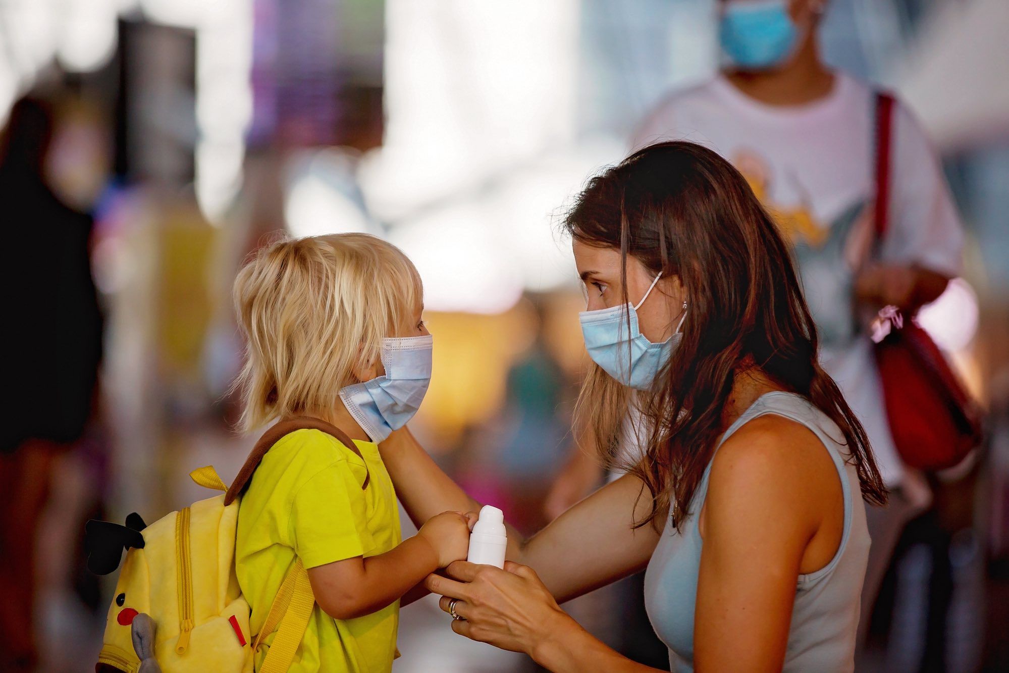 mother and child in face mask indoors as fines given to those who don't wear masks