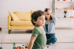 Upset mother with child regarding the sperm bank lawsuit claiming negligence in false sperm donor profile 