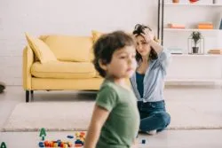 Upset mother with child regarding the sperm bank lawsuit claiming negligence in false sperm donor profile