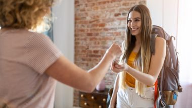 Woman handing keys to renter regarding the short-term rental bylaws in Toronto