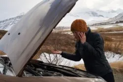 Woman having trouble with car in snow regarding the Dodge Ram class action lawsuit filed