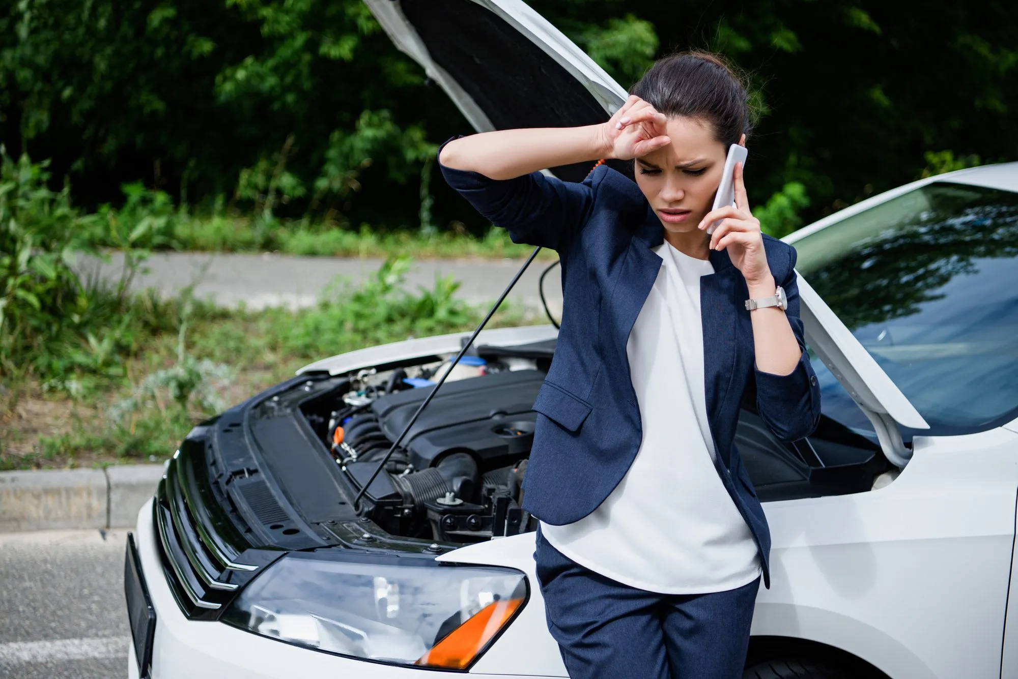 woman on phone with broken down car due to defective timing chain 