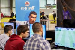 Teens playing video games regarding the EA games class action lawsuit filed