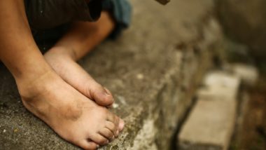 Closeup of child's dirty feet - defrauded indigenous foster children class action settlement - Robert Riley Saunders