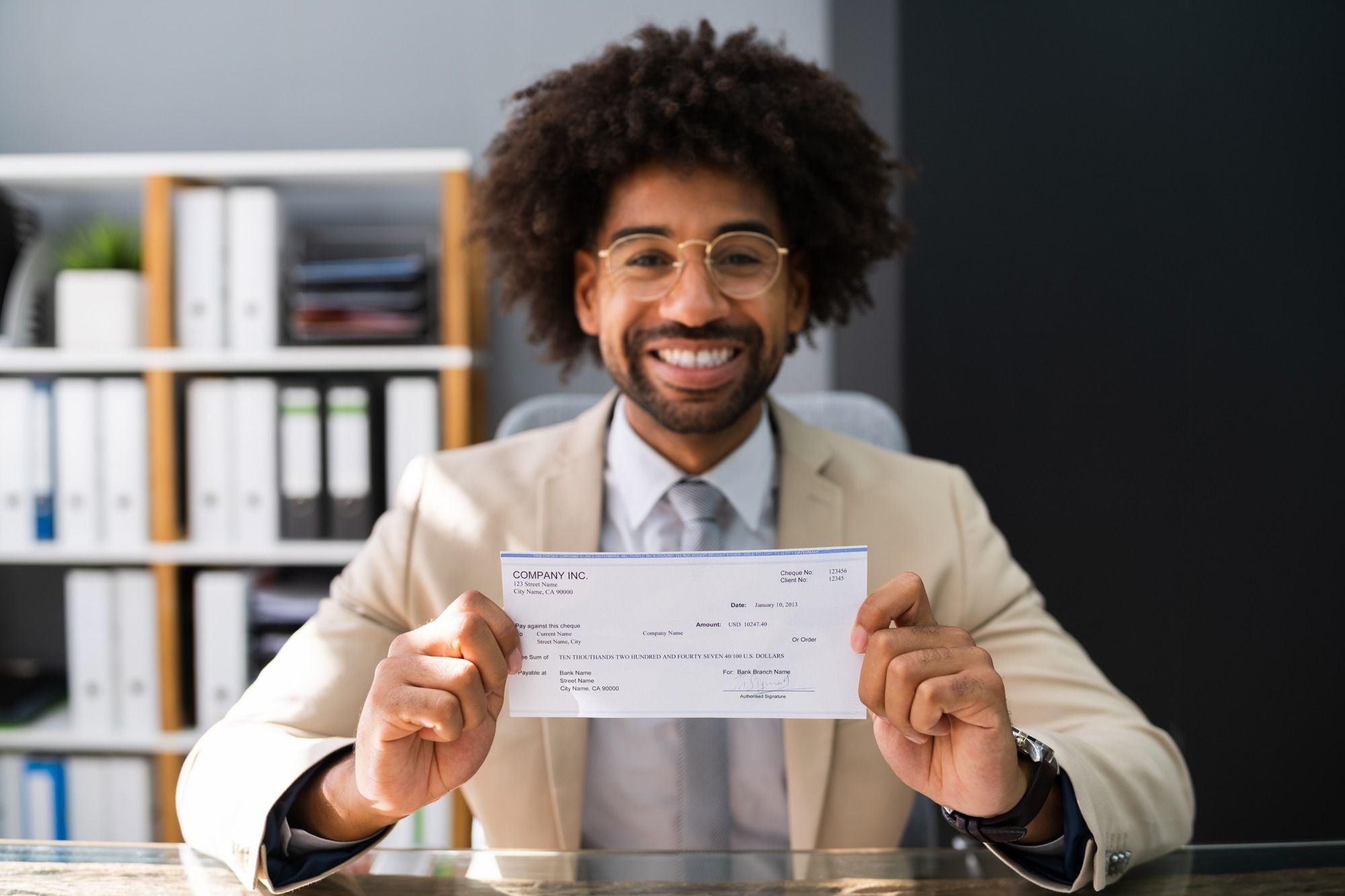 Man holding check regarding the Livingston Employee Overtime Class Action Settlement checks mailed
