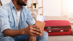 Man holding passport at home regarding the cancelled flight refunds class action lawsuit