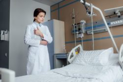 Nurse looking at empty hospital bed regarding the Indigenous family lawsuit claiming systemic racism 