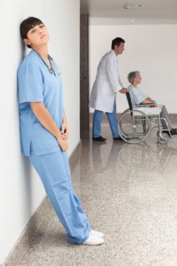 Stressed nurse without face mask regarding the West End Vill class action lawsuit filed