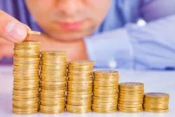 Person stacking coins regarding the TD Asset Management class action lawsuit filed