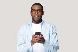 displeased man with cellphone regarding the Telus illegal cancelaltion fees class action lawsuit