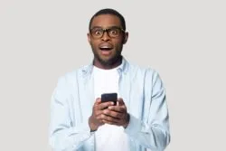 displeased man with cellphone regarding the Telus illegal cancelaltion fees class action lawsuit