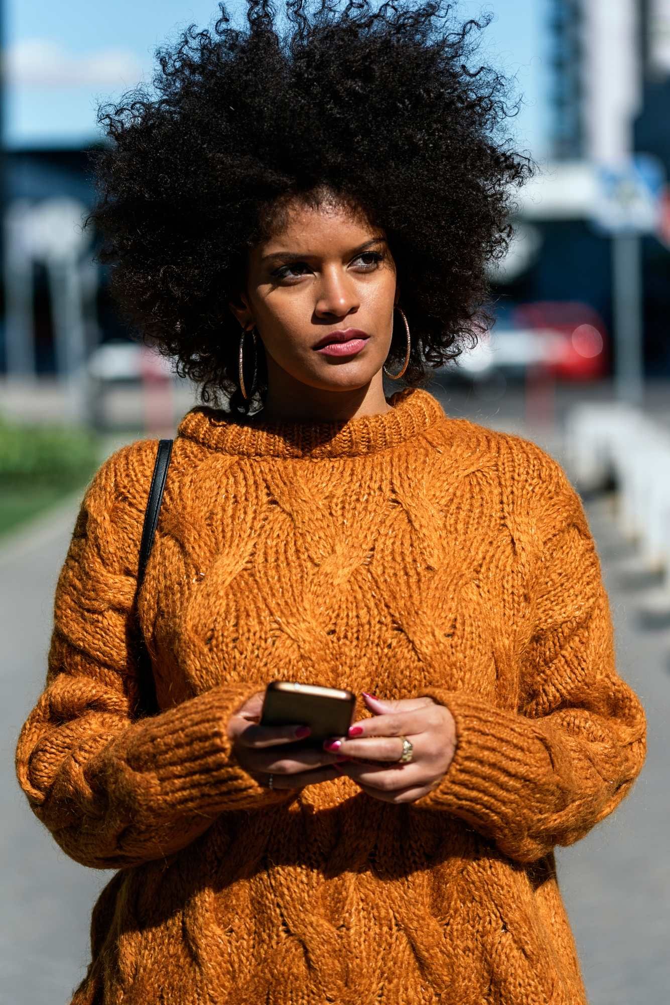 Woman using cell regarding the mobile app tracking class action lawsuit