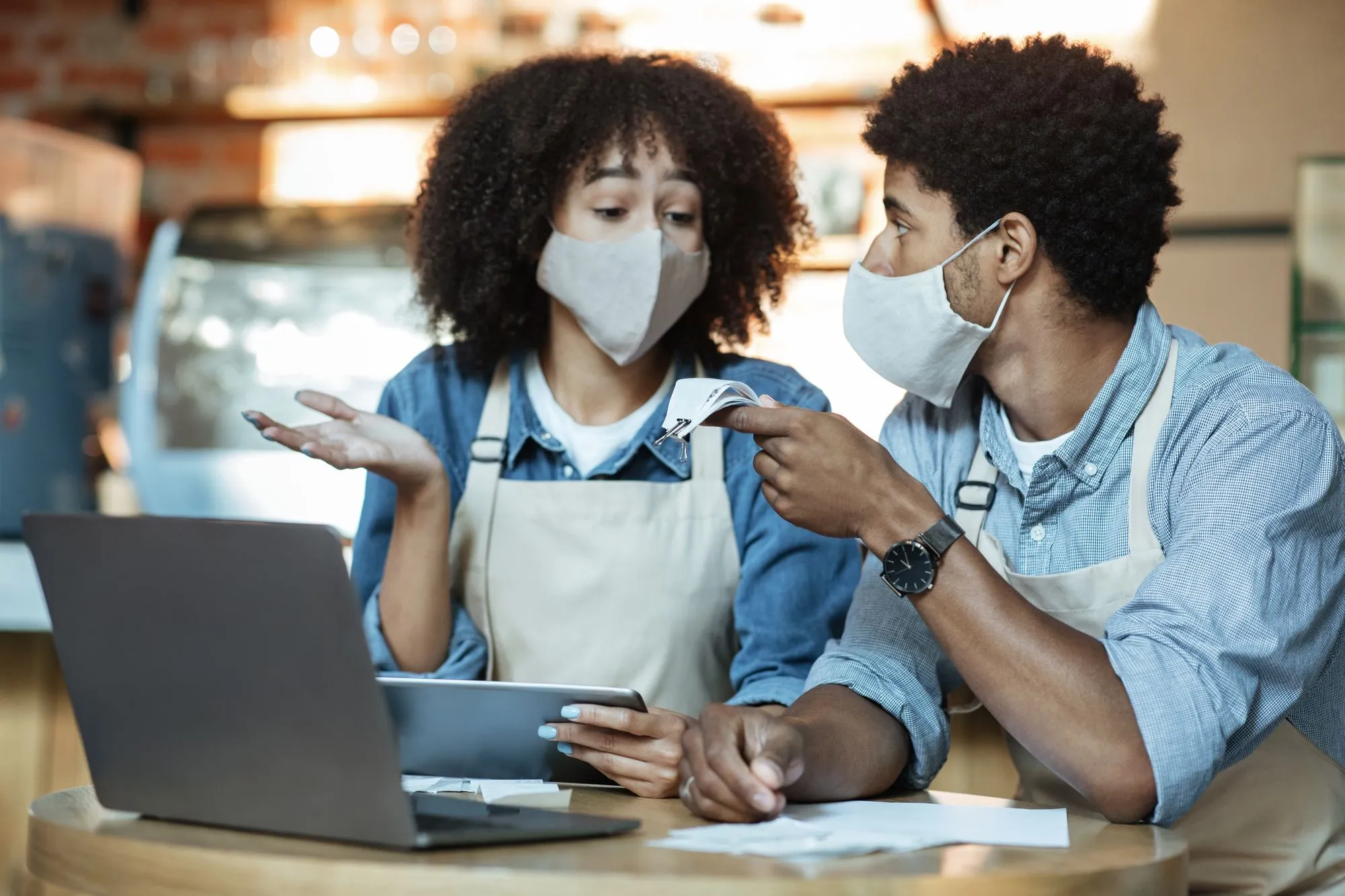 Cafe owners discussing finances regarding the Intact insurance company business interruption claims