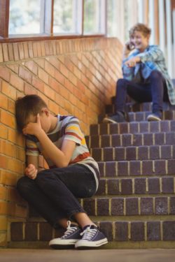 boy sitting on stairs crying