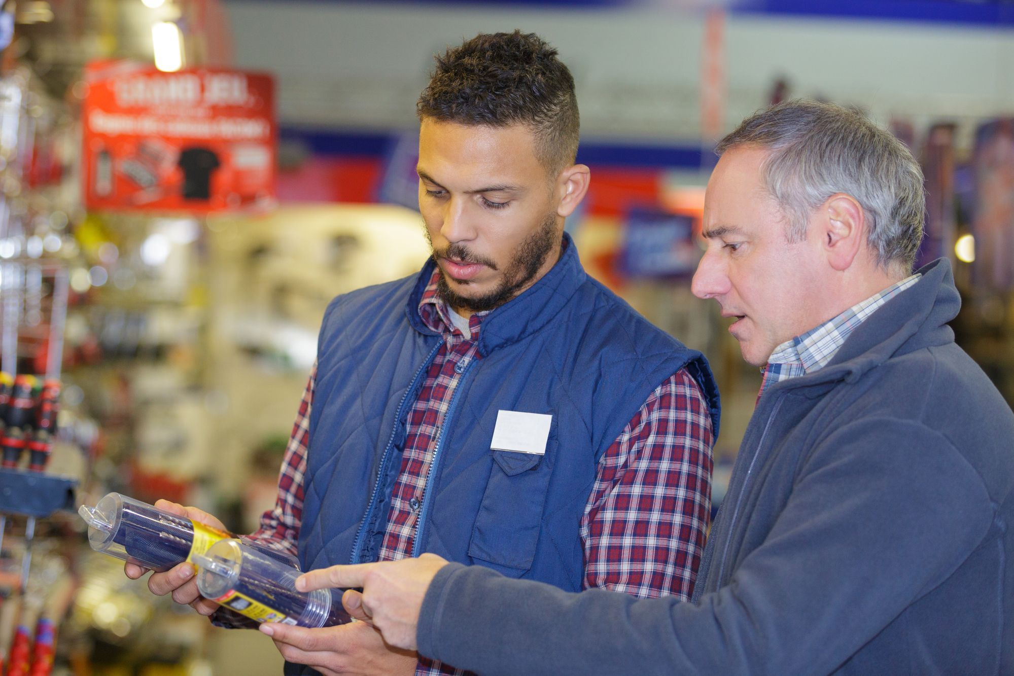 Men comparing paint thinners or varsol regarding the Recochen class action lawsuit