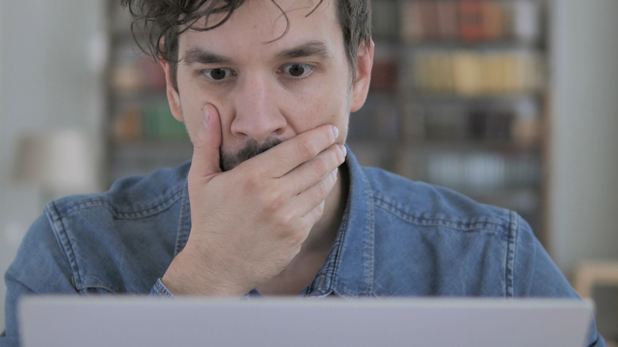 Man reading denial letter regarding information on when to file a SSQ long-term disability insurance lawsuit