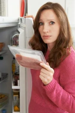 Woman checking food regarding the recent food recalls
