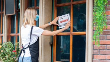 Restaurant hanging closed sign regarding the Allianz class action lawsuit filed over business interruption insurance