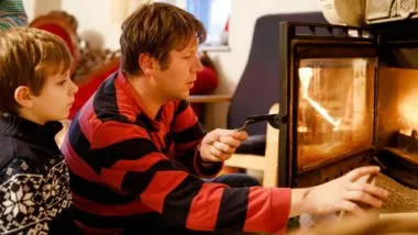 Dad and kid in front of fireplace regarding the hazardous products recalls