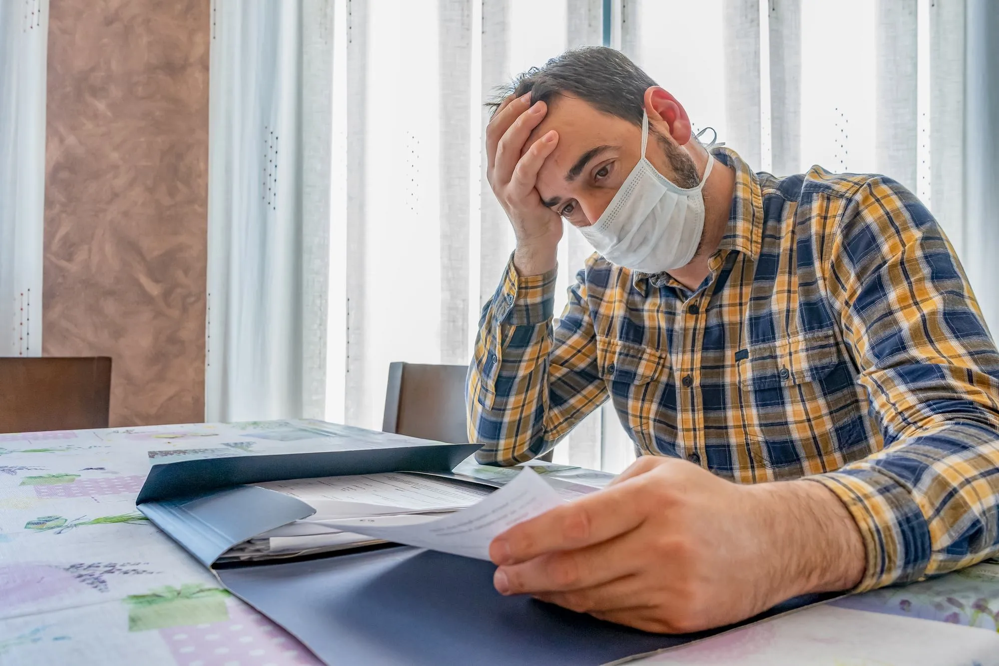 Frustrated business owner with calendar regarding the business interruption class action against Llyod's Underwriters