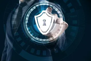 Businessman pushing button on virtual screen against dark background - dell data breach - ncix