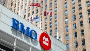 Flags fly atop a Bank of Montreal (BMO) building - BMO trust