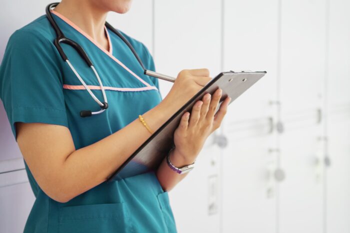 Woman Nurse holding a chart in a modern office