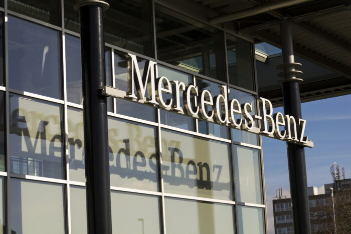 Mercedes-Benz car logo on dealership. Mercedes-Benz Diesel Emissions Settlement 