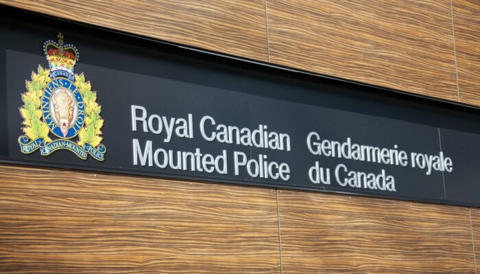 VANCOUVER, CANADA - JANUARY 26, 2015: A sign for the Royal Canadian Mounted Police in English and French along with the crest of the RCMP.