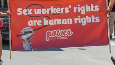 Women carrying a banner about sex workers'