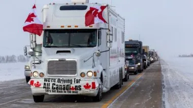 EMERSON, CANADA - JANUARY 29, 2022: Freedom Convoy 2022. Truckers and supporters protest mandatory vaccinations in Canada.