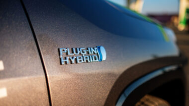 Close up of embossed text that says 'plug in hybrid' on a Toyota RAV4 Hybrid vehicle.