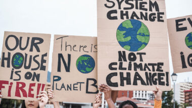 Young group of demonstrators on road from different culture and race protest for climate change.