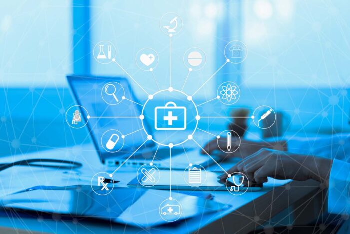 Close up of a doctor using a laptop with a data breach overlay, representing the CarePartners data breach settlement.